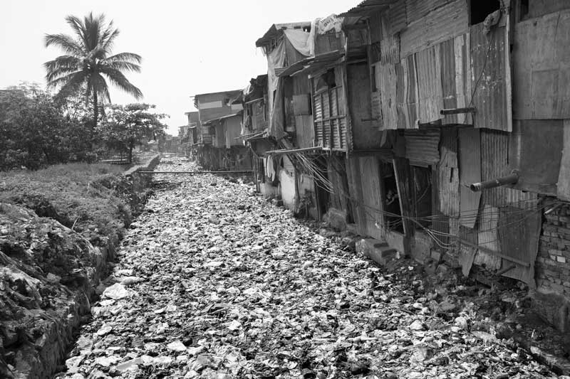 Chamdawadi drain filled with solid waste in Mumbai, Maharashtra, adding toxic chemical contaminants to the drain's untreated wastewater, which further pollutes Mithi River into which it finally drains